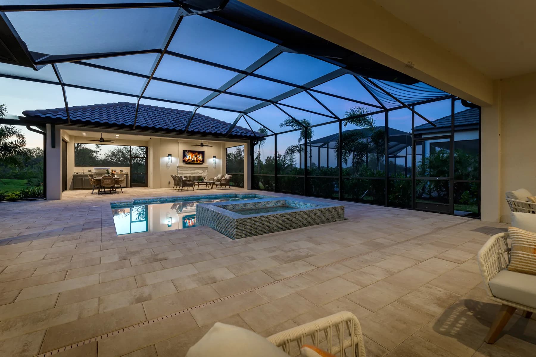 Screened pool and lanai at twilight at the Edgewater model by Sam Rodgers Homes