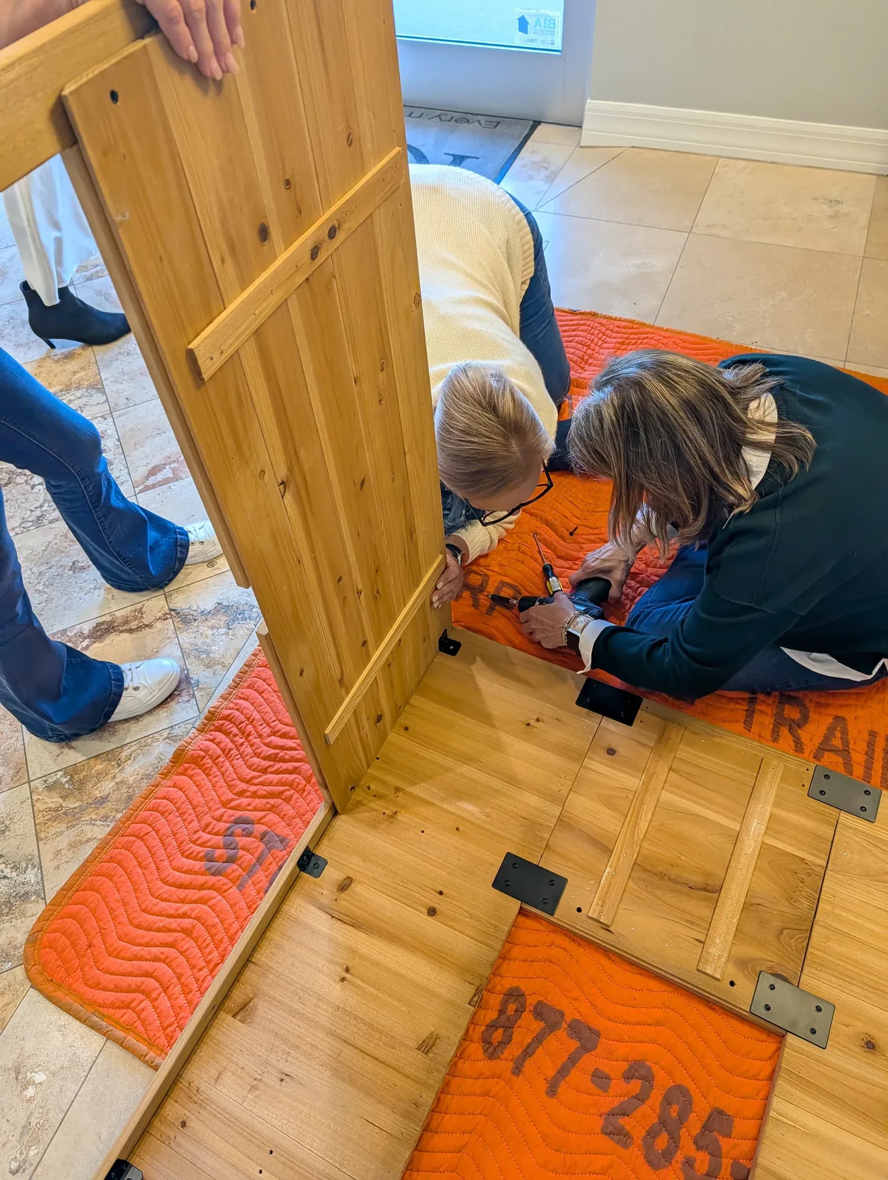 Lifting a full-height wall panel into place.