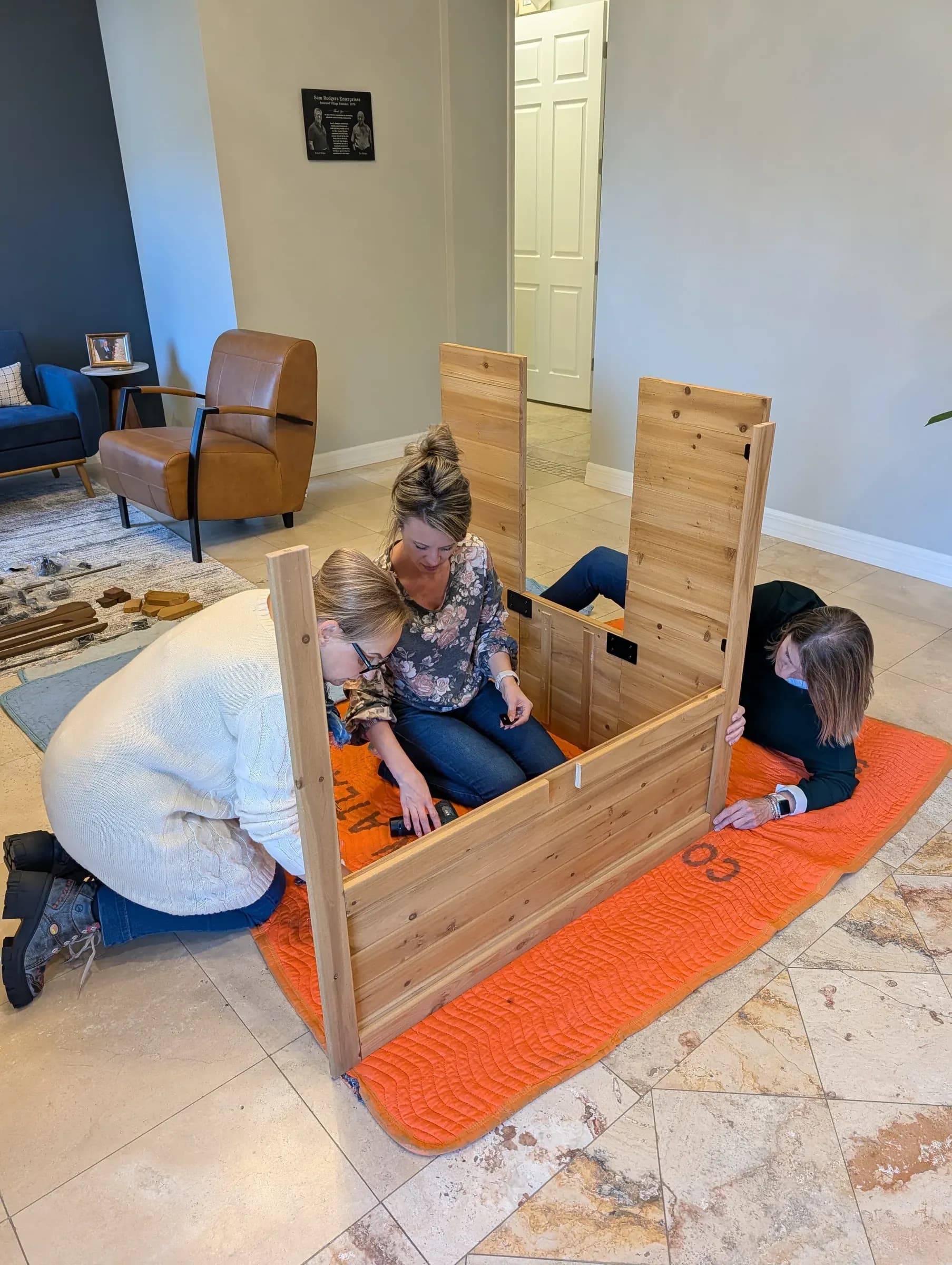 Fitting the floor from inside the half-built frame.