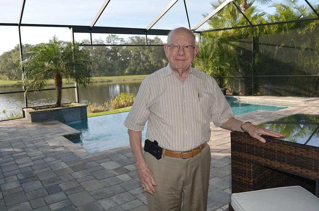 Sam Rodgers on a screened lanai overlooking the water at GreyHawk Landing