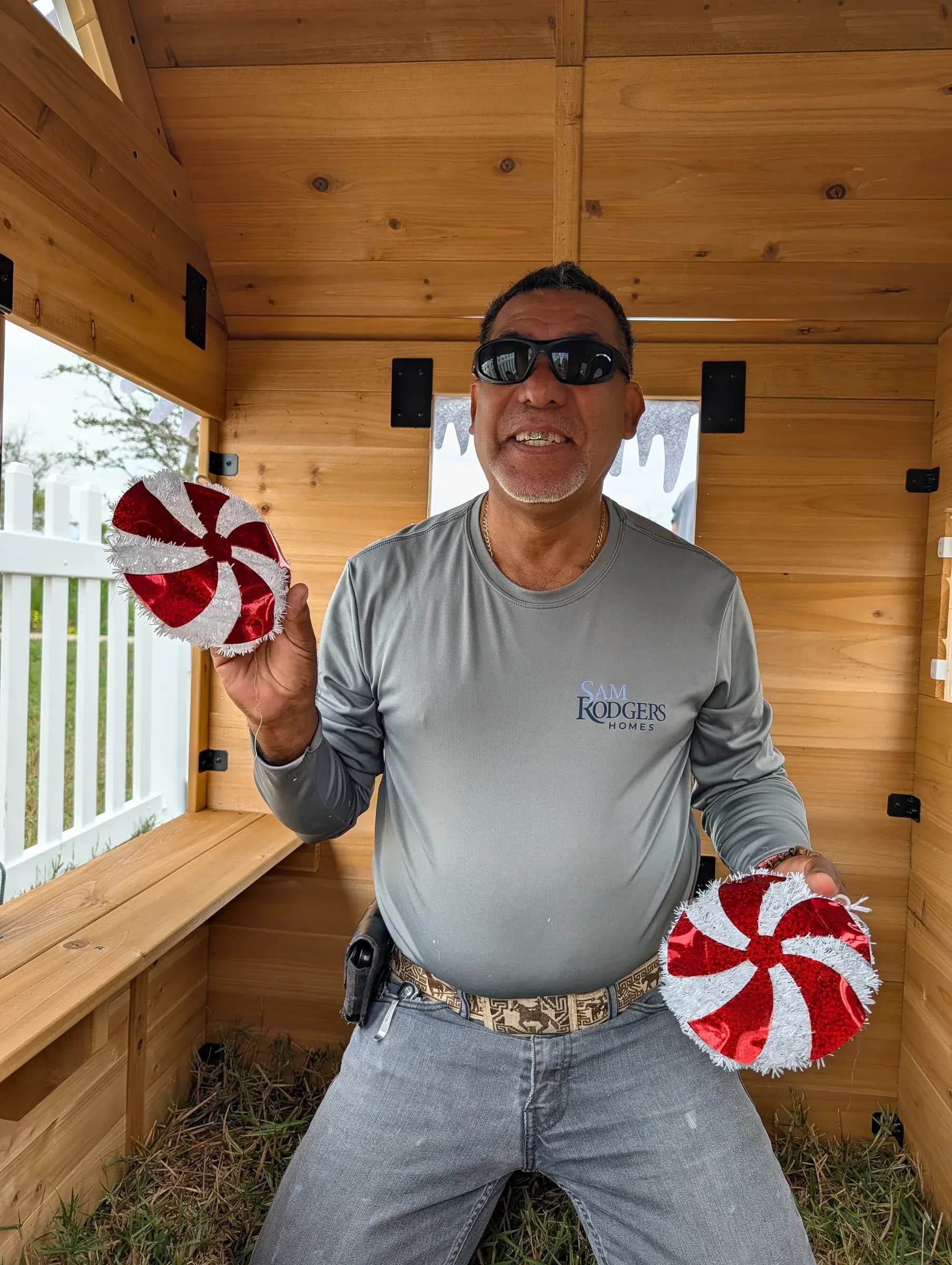 Holding up two peppermint discs from inside the finished cottage.