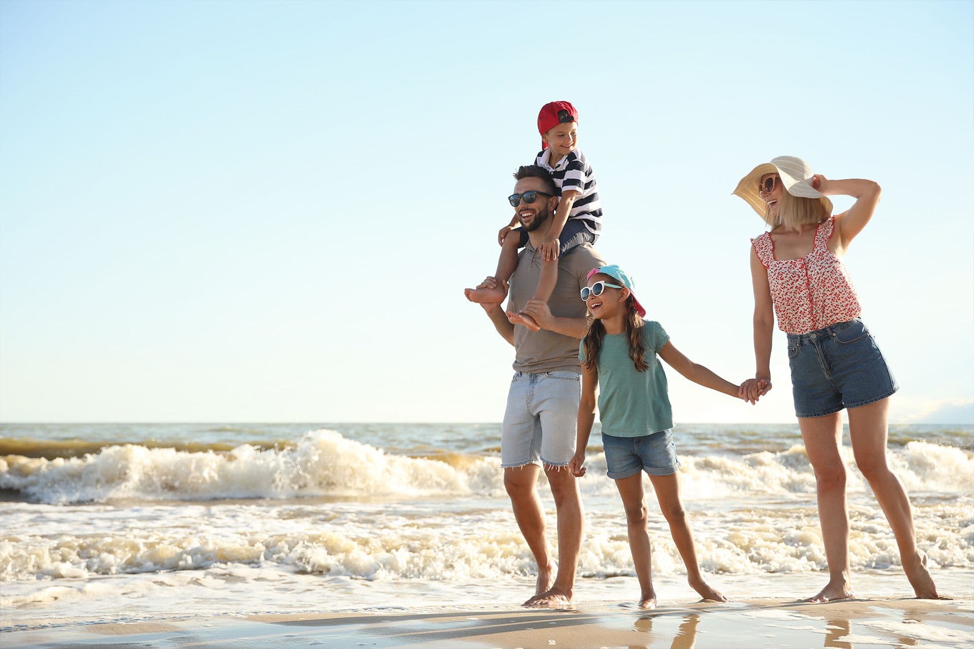 Family at the water's edge on a Gulf Coast beach near Wellen Park, Venice FL