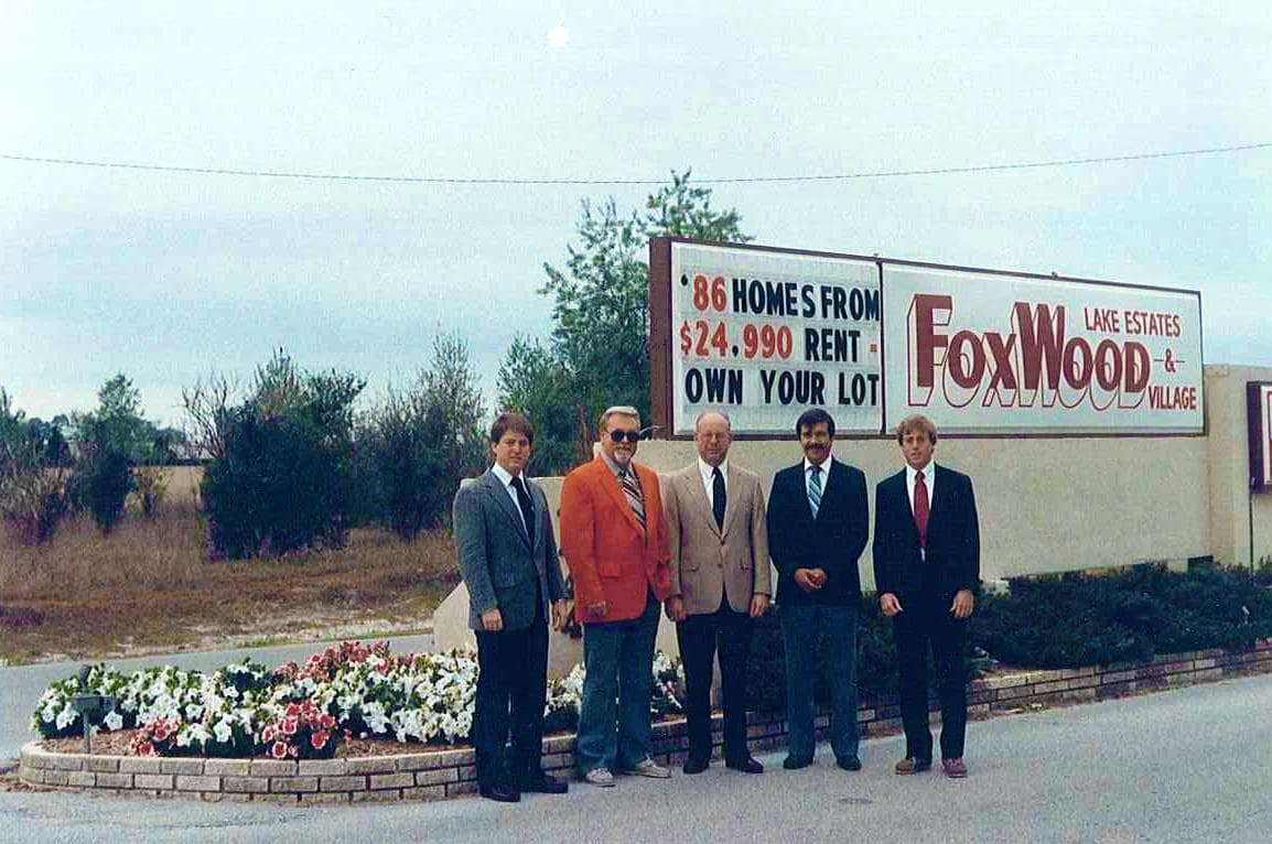Sam Rodgers and colleagues at the Foxwood Lake Estates & Village entrance sign