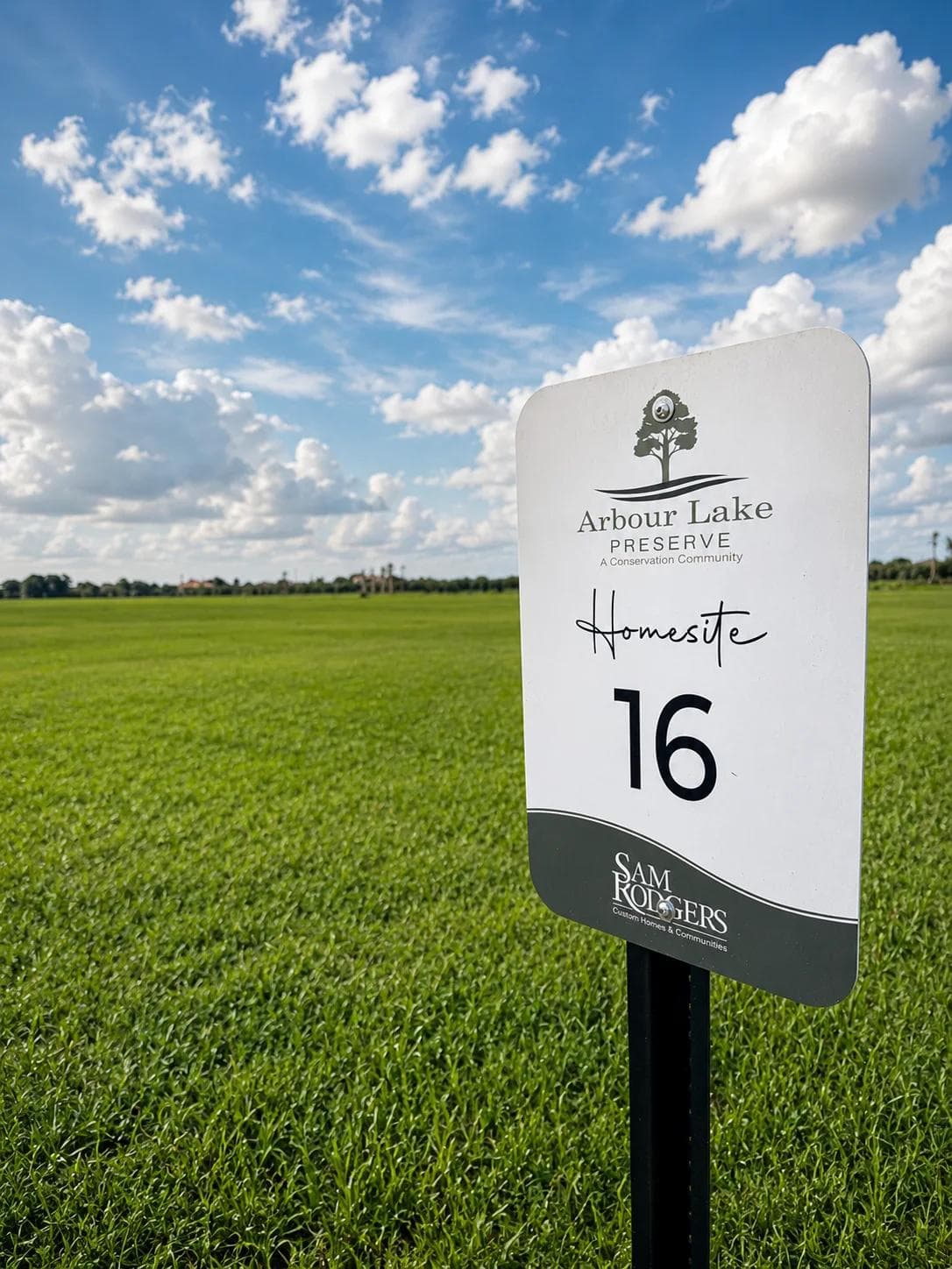 Arbour Lake Preserve Homesite 16 marker in an open meadow under a blue Florida sky