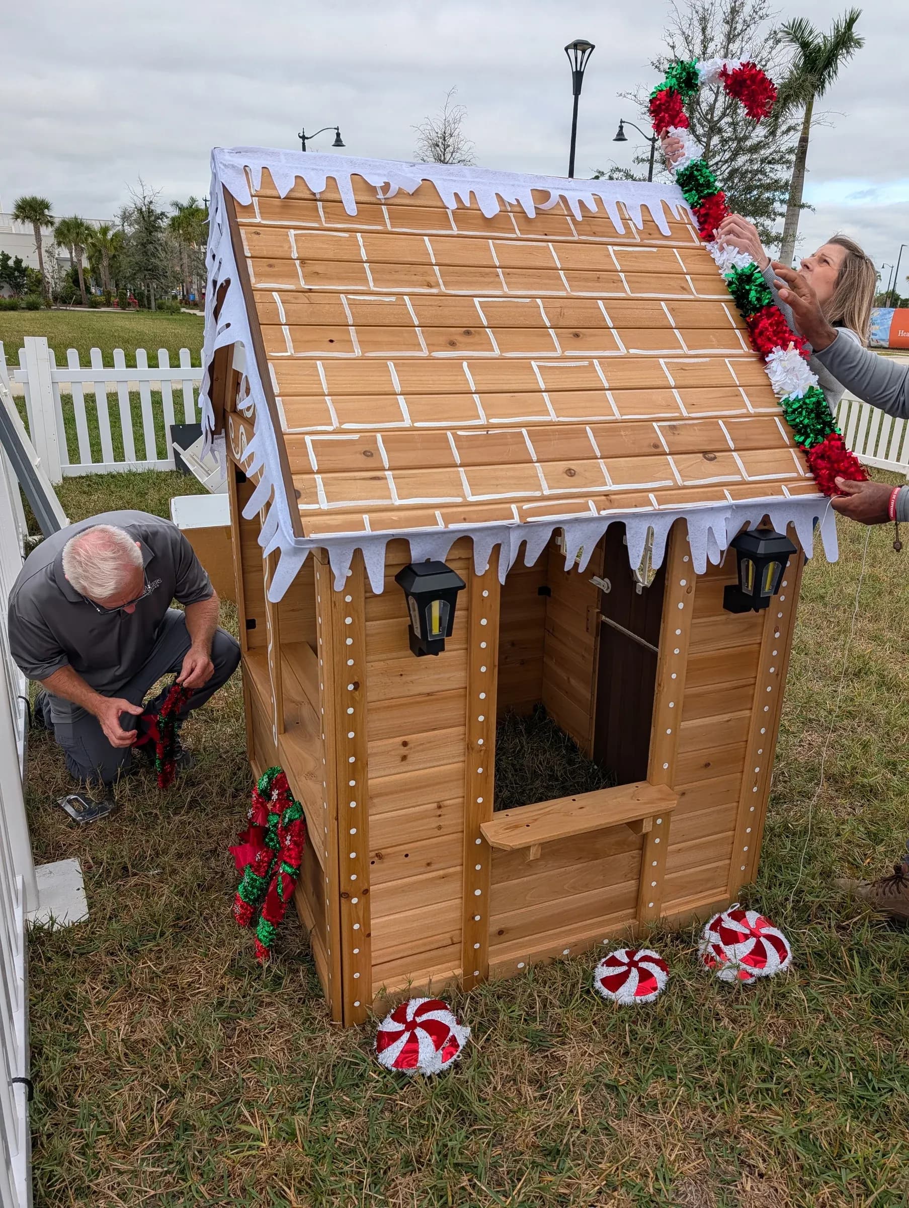 On the green at Wellen Park, fixing the iced roof trim and hanging garland.